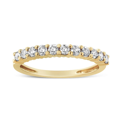 Yellow metal ring with a row of round white gemstones in prong settings, shown from the side angle.