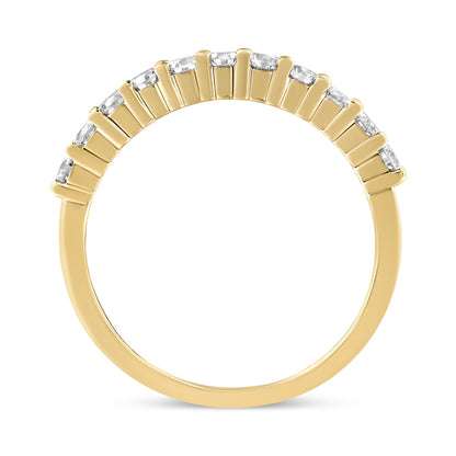 Close-up front view of a yellow metal ring set with a row of round white gemstones in prong settings along the band top.