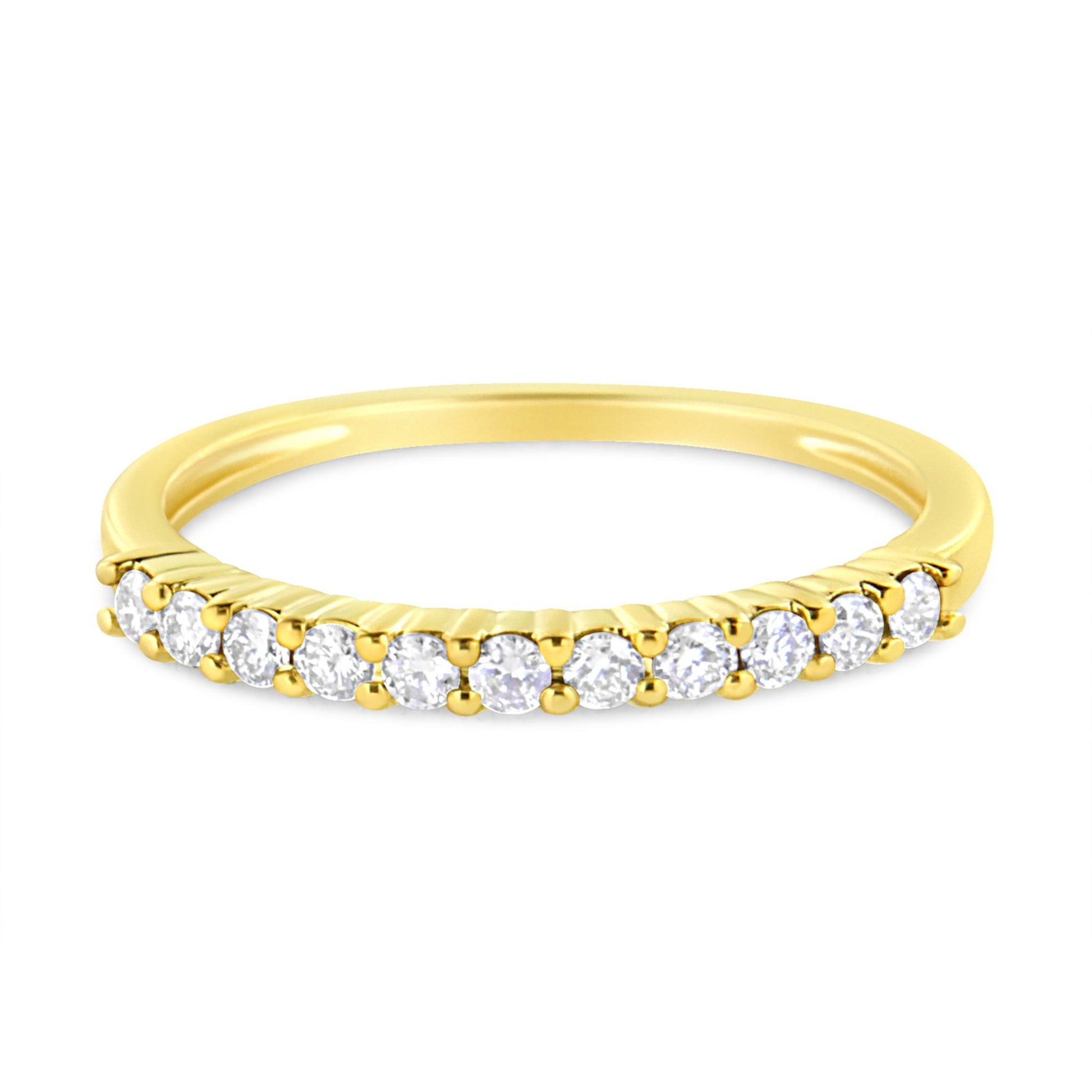 Yellow metal ring shown from a slightly elevated front angle, featuring a row of round white gemstones in prong settings along the band.