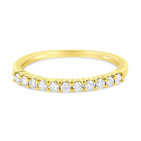 Yellow metal ring shown from a slightly elevated front angle, featuring a row of round white gemstones in prong settings along the band.