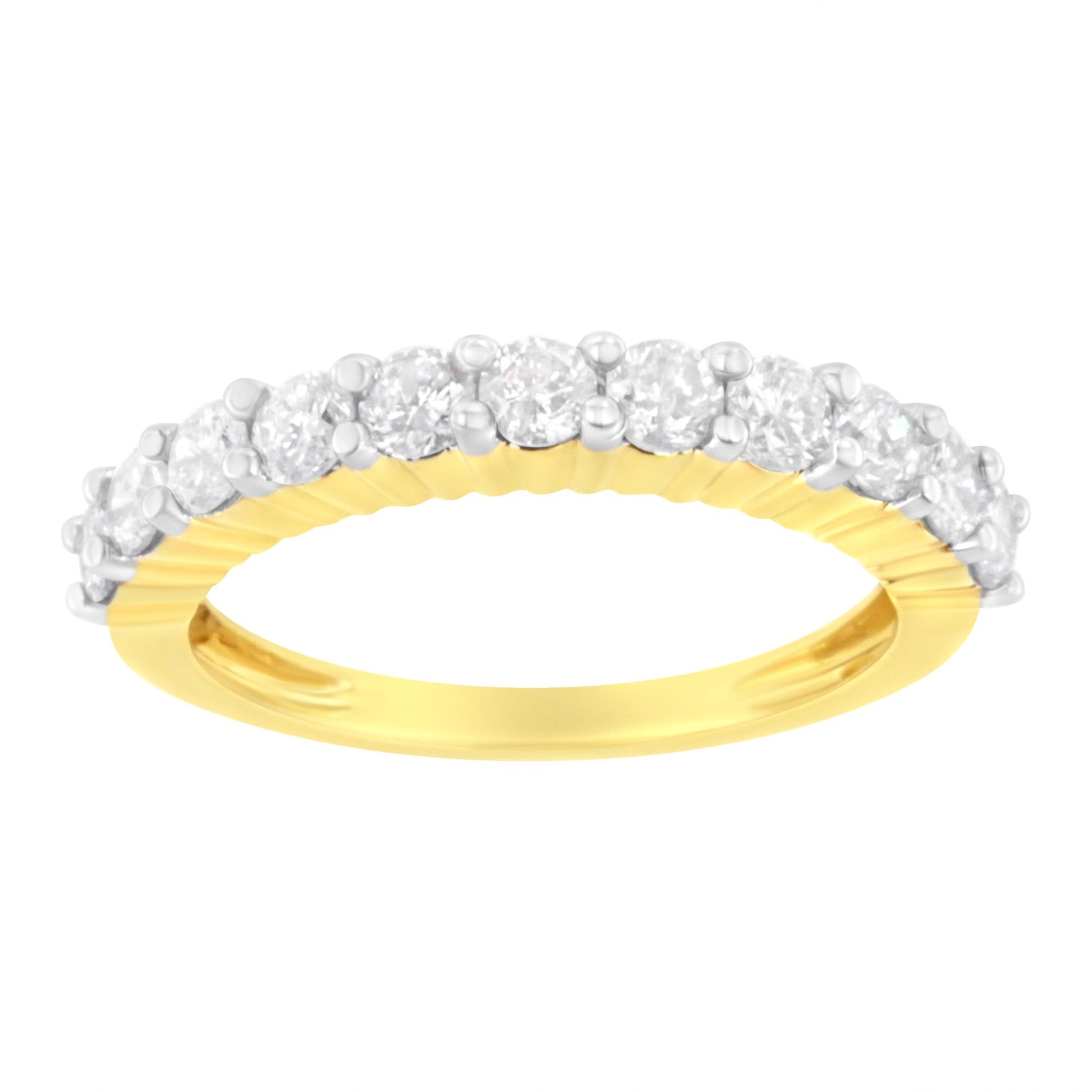Close-up front angle of a yellow ring with a row of round white gemstones in shared prong setting on top.
