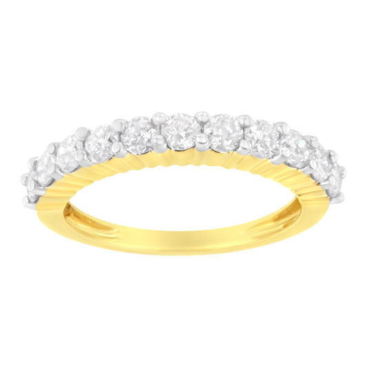 Close-up front angle of a yellow ring with a row of round white gemstones in shared prong setting on top.