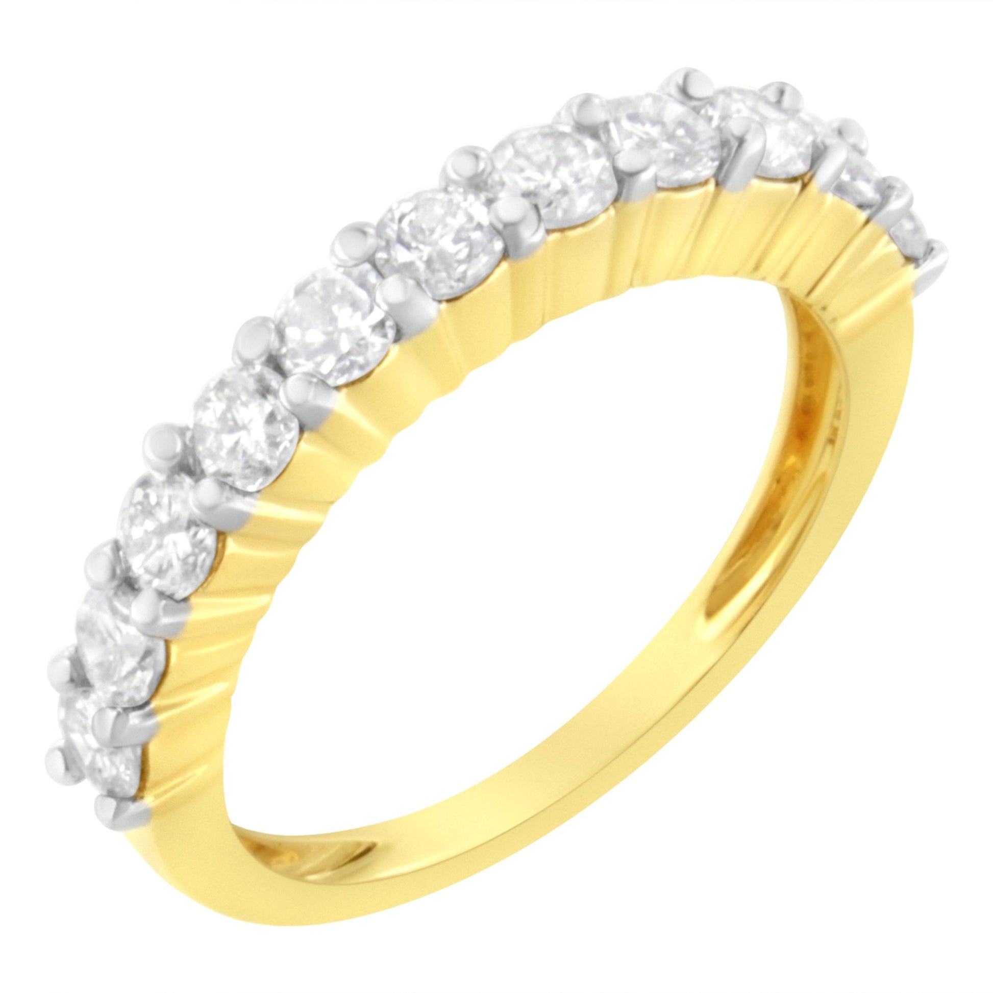 Yellow metal ring with a row of round white gemstones in shared prong setting, shown at a slight angle.