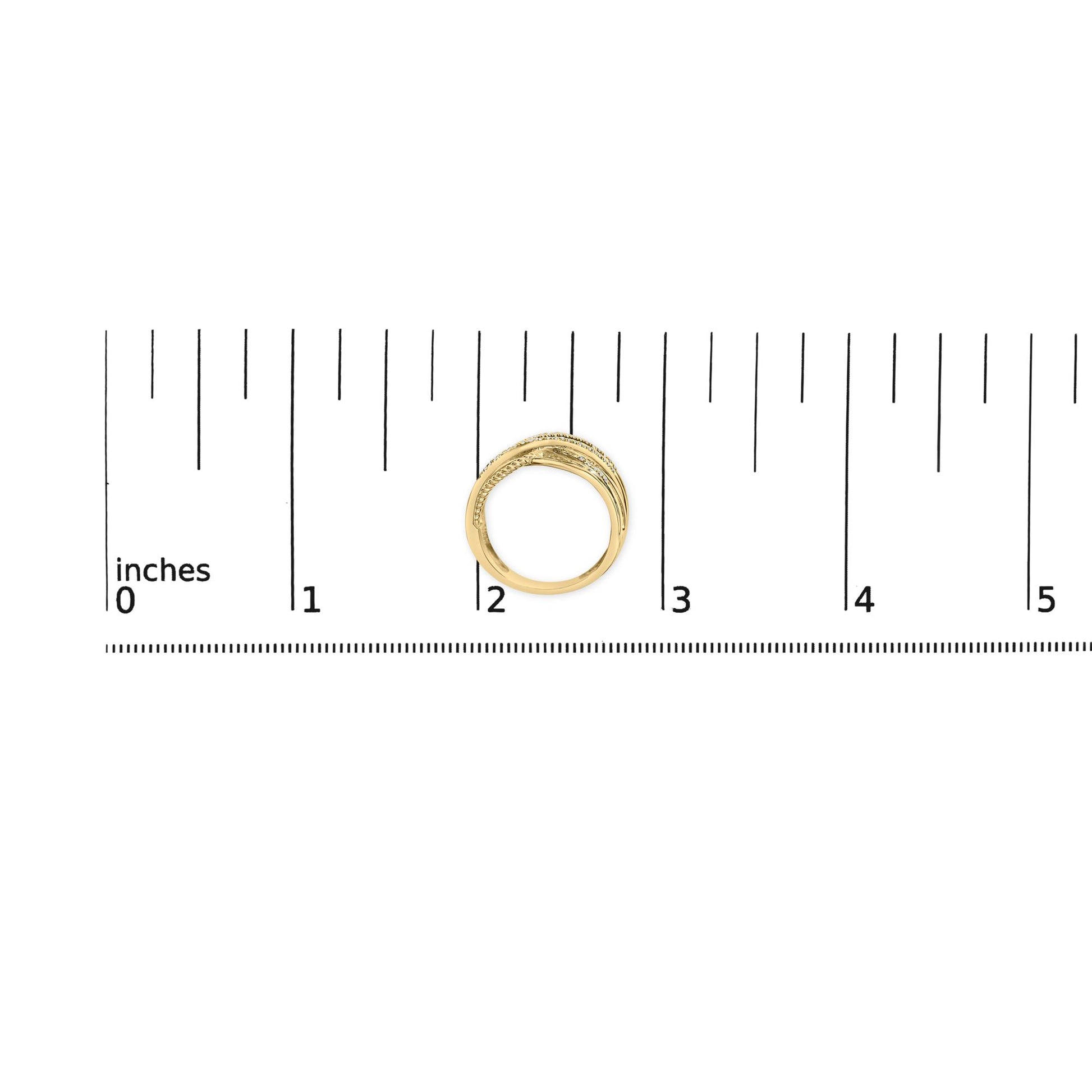 Yellow and white metal ring with round white gemstones in prong setting, placed on a ruler for size reference, top-down angle.