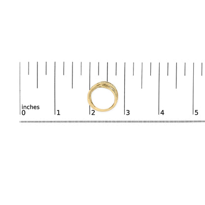 Yellow and white metal ring with round white gemstones in prong setting, placed on a ruler for size reference, top-down angle.