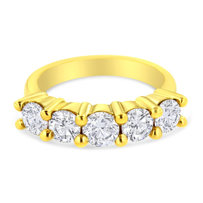 Yellow metal ring with five round white gemstones in prong setting, shown in a front angled close-up.