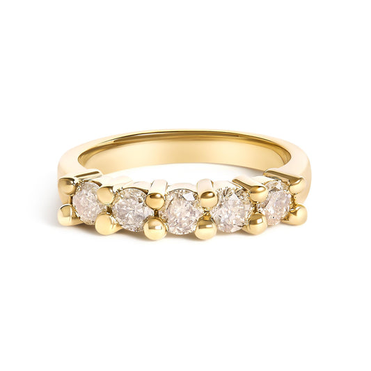 Yellow ring with five round white gemstones in prong settings, shown from a front angle.