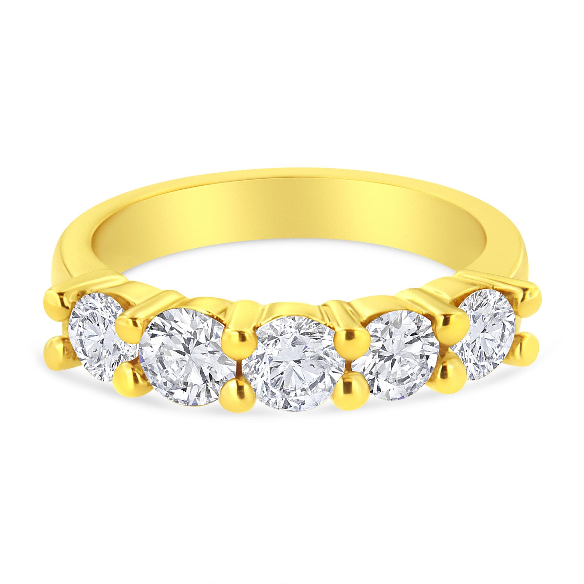 Yellow metal ring with five round brownish prong-set gemstones, shown from a front angle.
