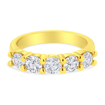 Yellow metal ring with five round brownish prong-set gemstones, shown from a front angle.