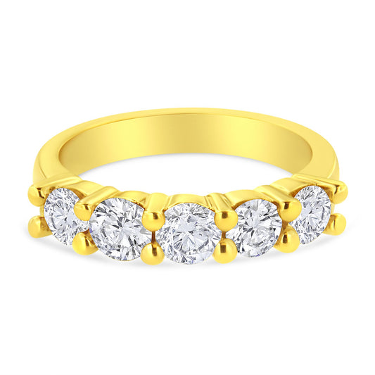 Yellow metal ring with five round brownish prong-set gemstones, shown from a front angle.