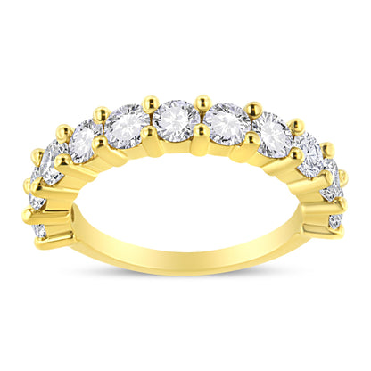 Yellow metal ring with round white gemstones in prong setting, shown from side angle.