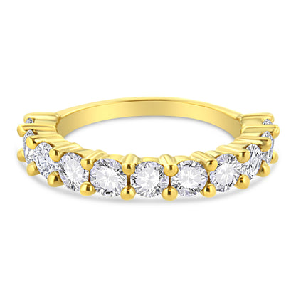 Yellow metal ring with round white gemstones in prong settings, front angle view.