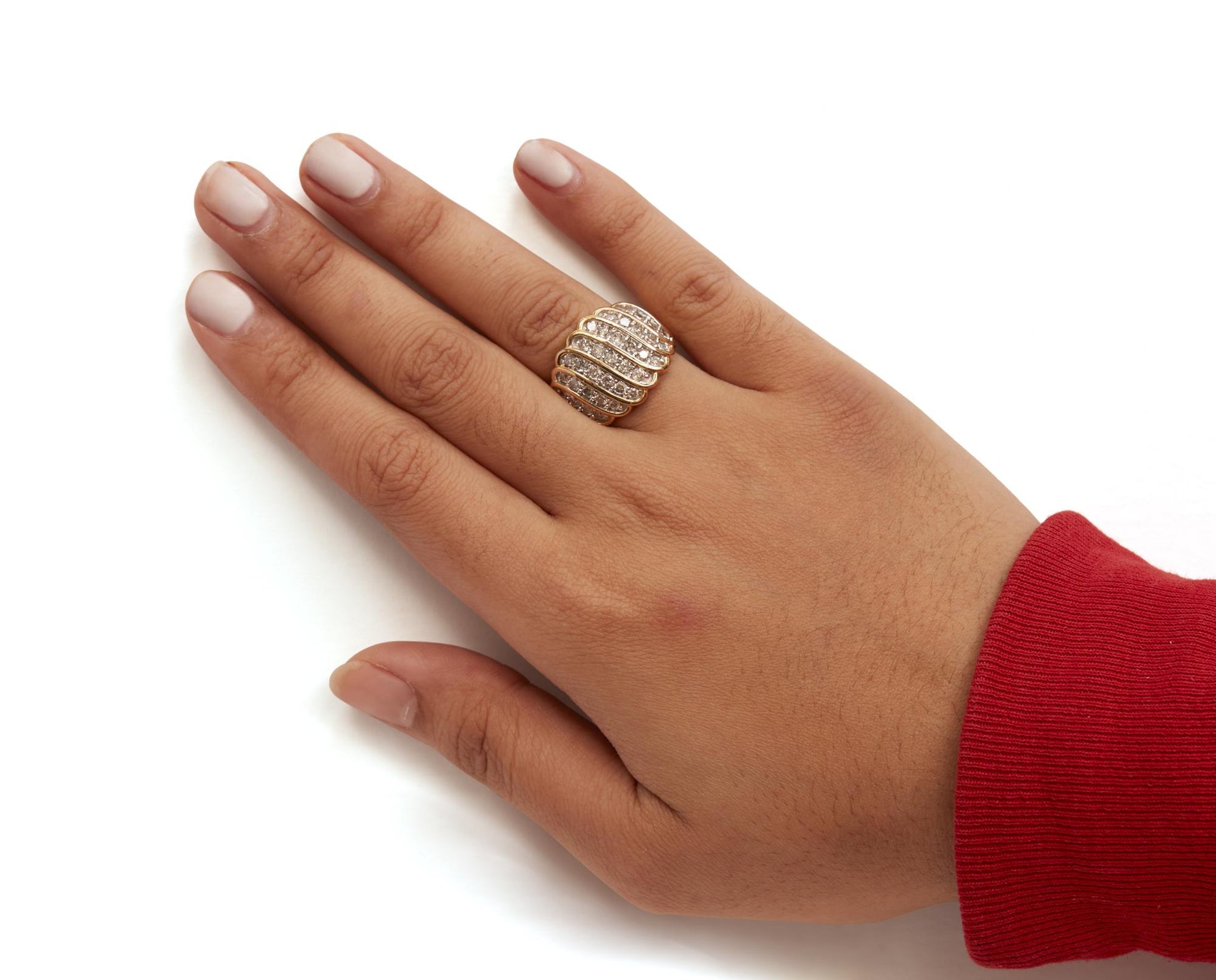 Close-up angled view of a yellow metal ring adorned with rows of white round prong-set gemstones, worn on a model's finger.