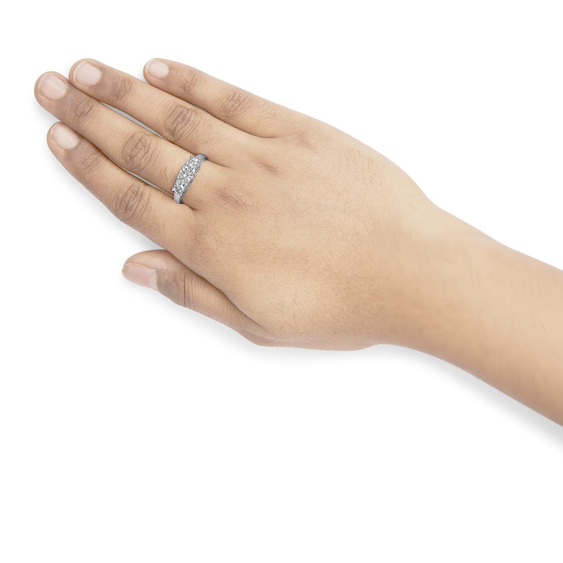 White metal ring with three round-shaped white gemstones in miracle settings, worn on a model's hand, shown from a top angled view.