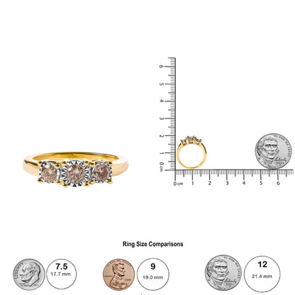 Yellow ring with three round white gemstones in miracle settings, shown from front and side view on a scale for size reference.