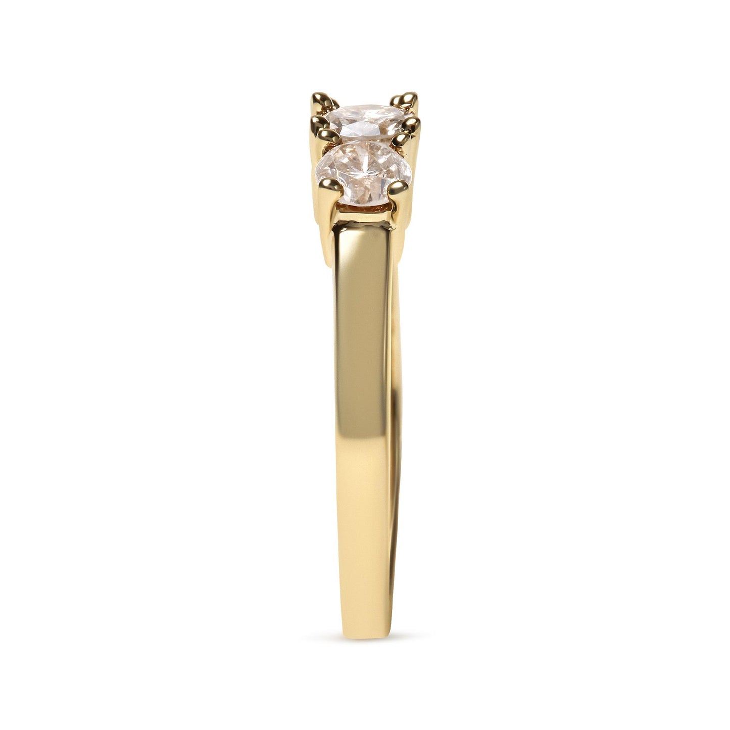 Side view of a yellow metal ring with three round white gemstones in prong settings.