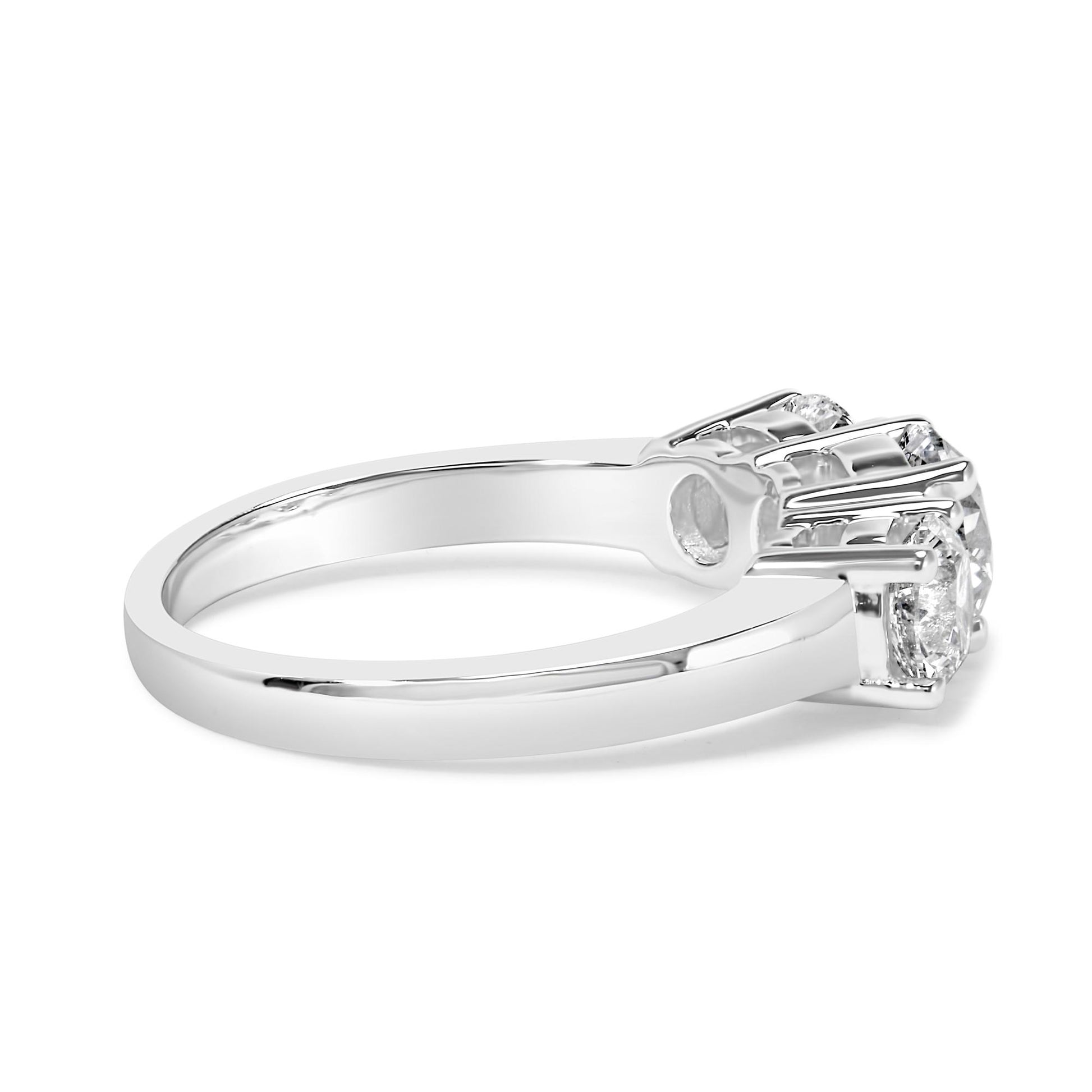 Side view of a white metal ring featuring one round white gemstone in a 4-prong setting and two round white gemstones in 4-prong settings.