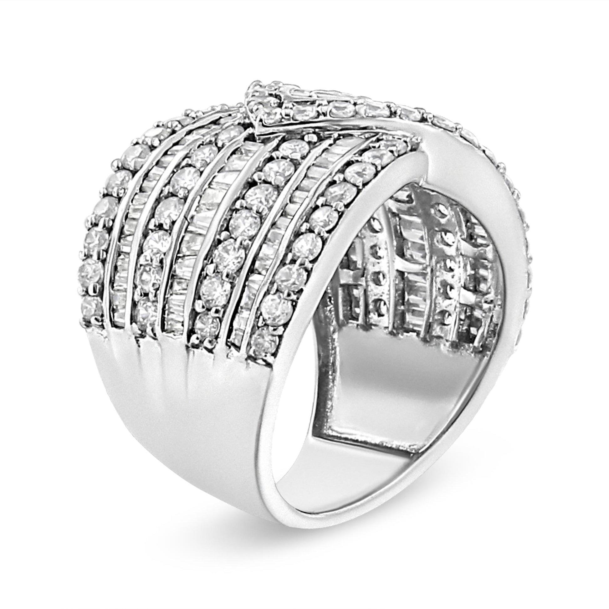 White metal ring with alternating rows of prong-set round white gemstones and channel-set baguette white gemstones, shown at a slight angle.