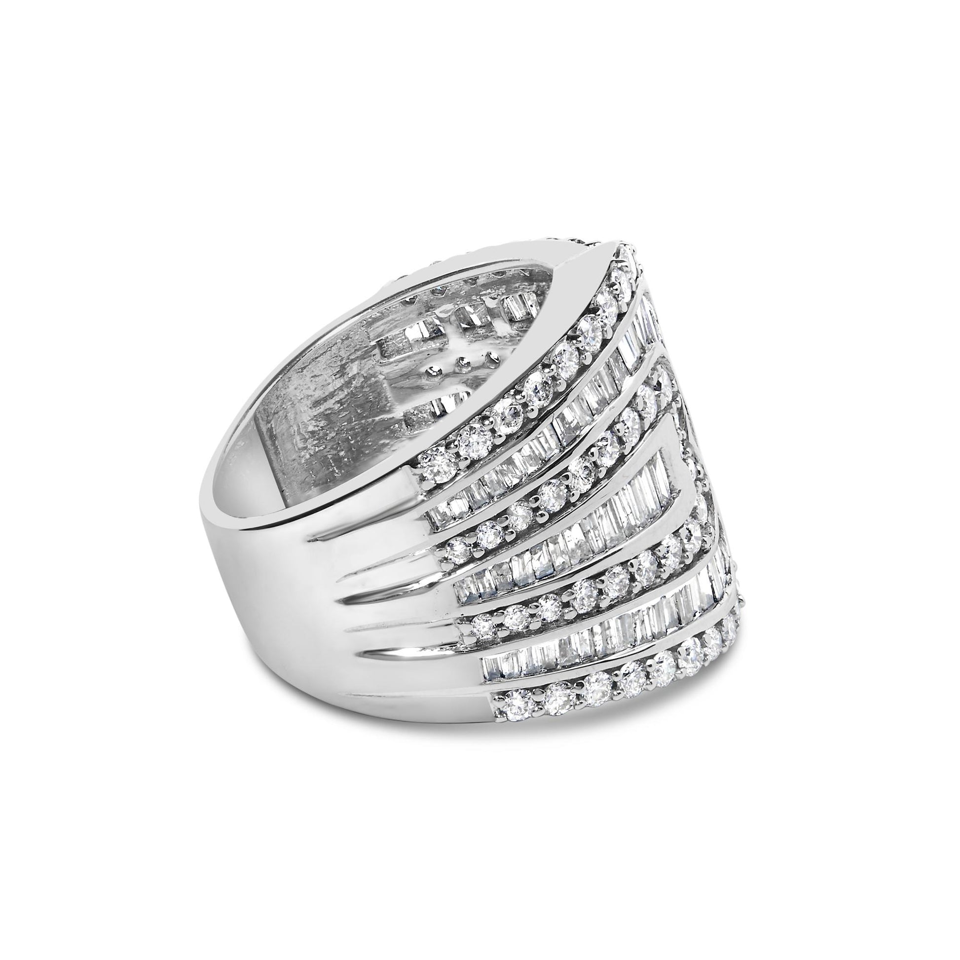 White metal ring with alternating rows of round prong-set white gemstones and baguette channel-set white gemstones, shown in a side angled view.