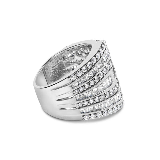 White metal ring with alternating rows of round prong-set white gemstones and baguette channel-set white gemstones, shown in a side angled view.