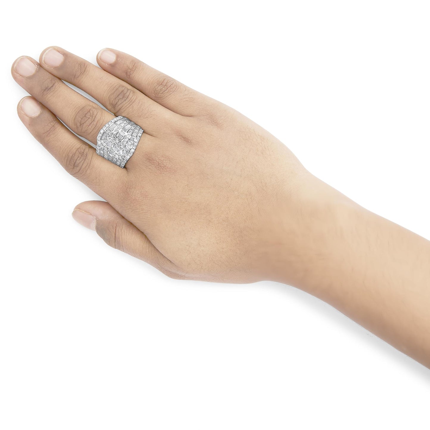 Close-up angled shot of a white metal ring with round white gemstones in prong settings and baguette white gemstones in channel settings, worn on a hand.