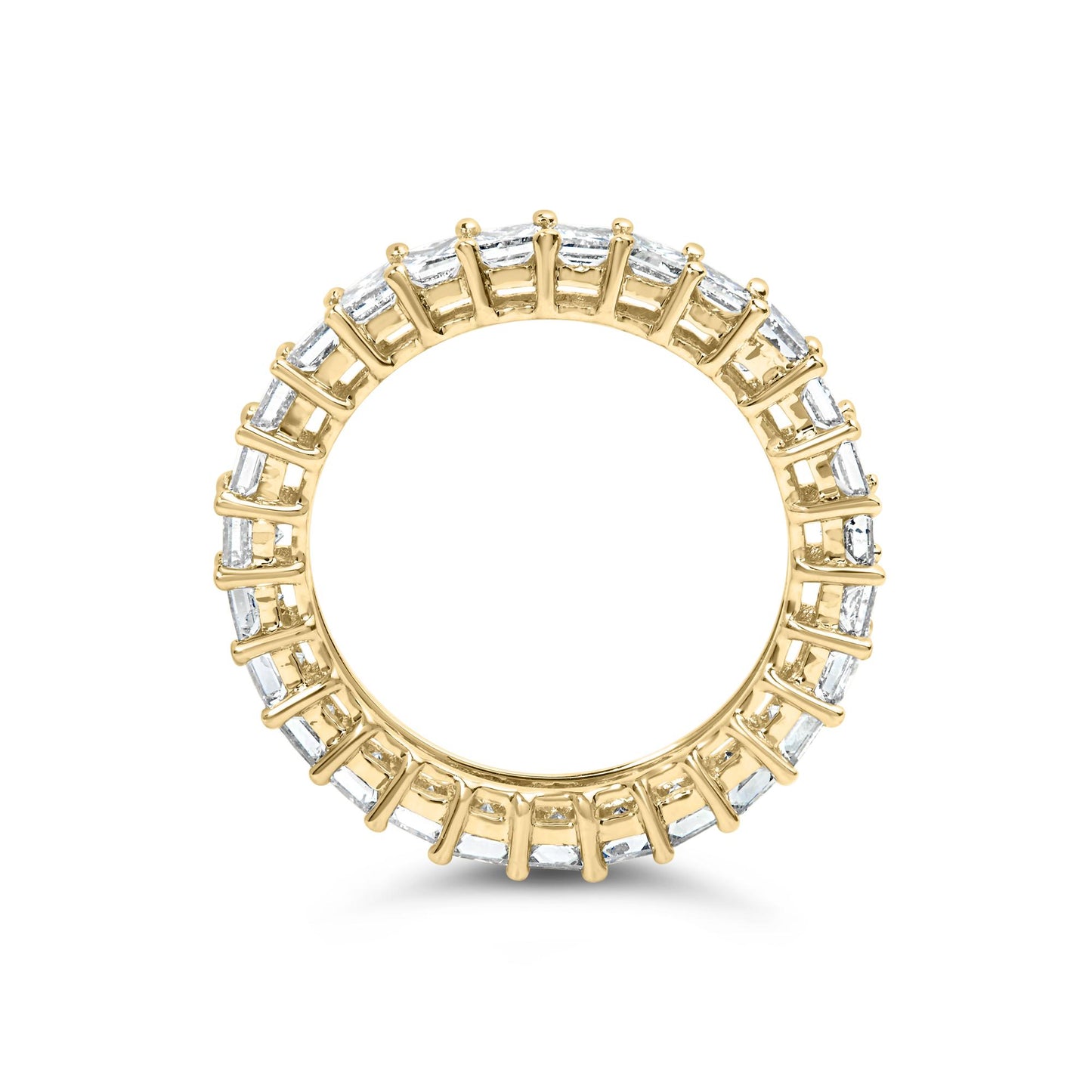 Top-down view of a yellow metal ring with white princess-shaped gemstones set in prongs encircling the band.