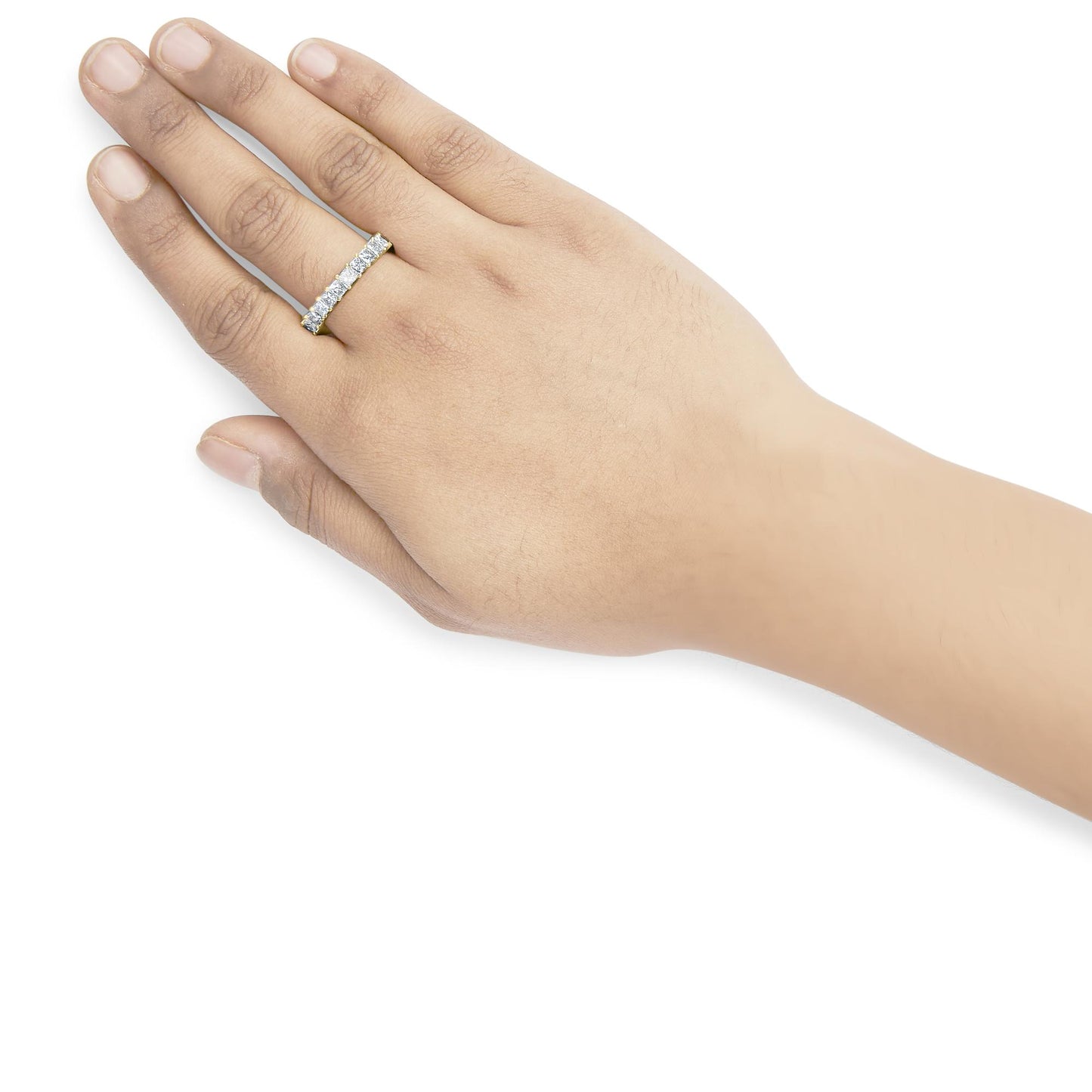 Yellow ring with prong-set white princess-shaped gemstones worn on a model’s hand, shown from a top angled view.