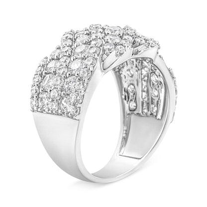 White metal ring with multiple rows of round white gemstones in prong setting, shown at a slight angle.