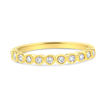 Yellow ring with round prong-set white gemstones around half the band, shown from a front angle.