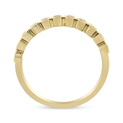 Yellow metal ring viewed from the side with round prong-set brownish gemstones on the upper half.