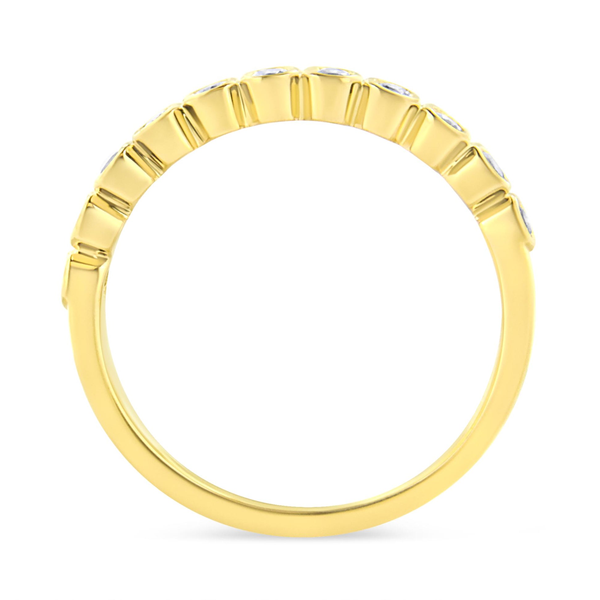 Yellow metal ring shown from the side with round brownish gemstones in prong settings along the top half.