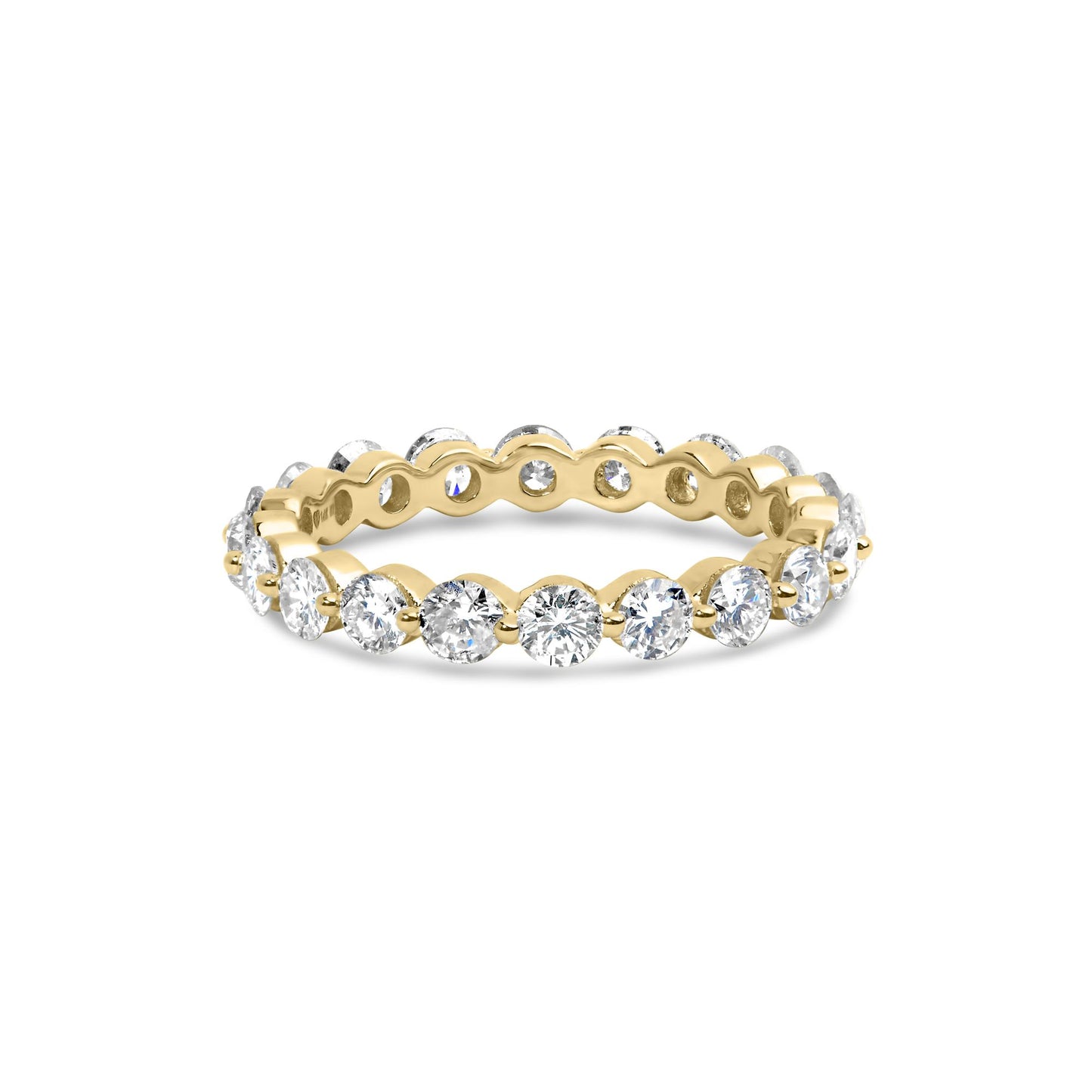 Yellow metal ring with round white gemstones in prong settings around the band, shown from a slightly elevated front angle.