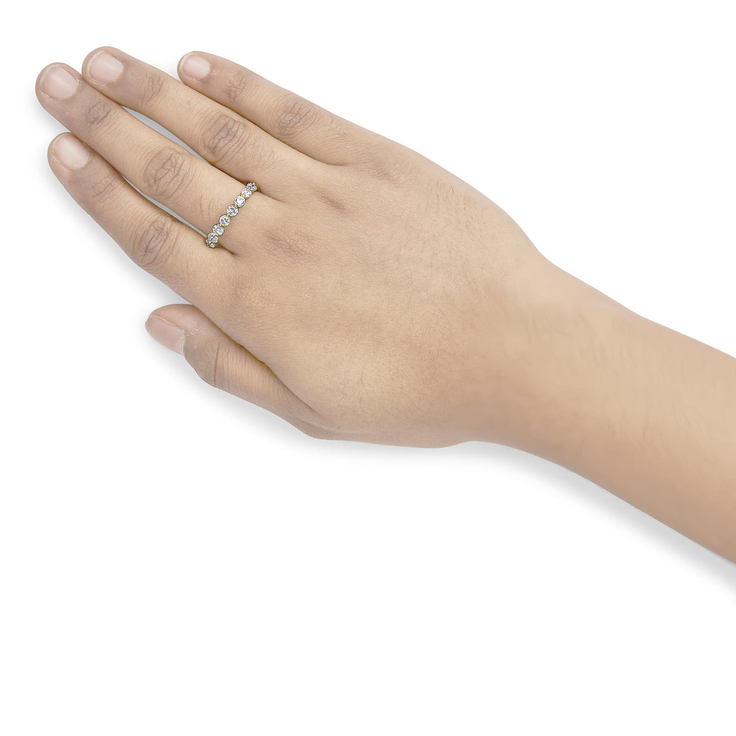 Close-up of yellow ring with round white gemstones in prong setting, worn on finger, side angle.