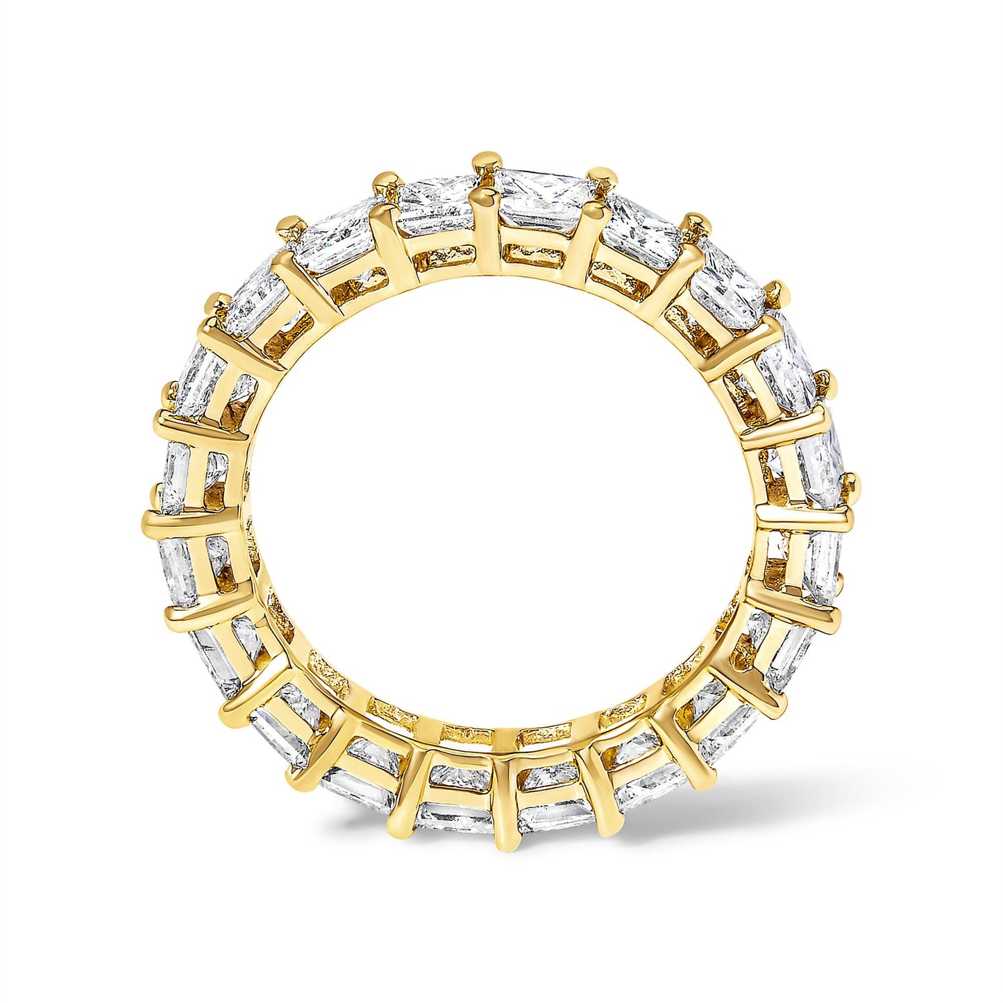 Yellow metal ring with princess-shaped white gemstones in prong settings, photographed from a front angle.