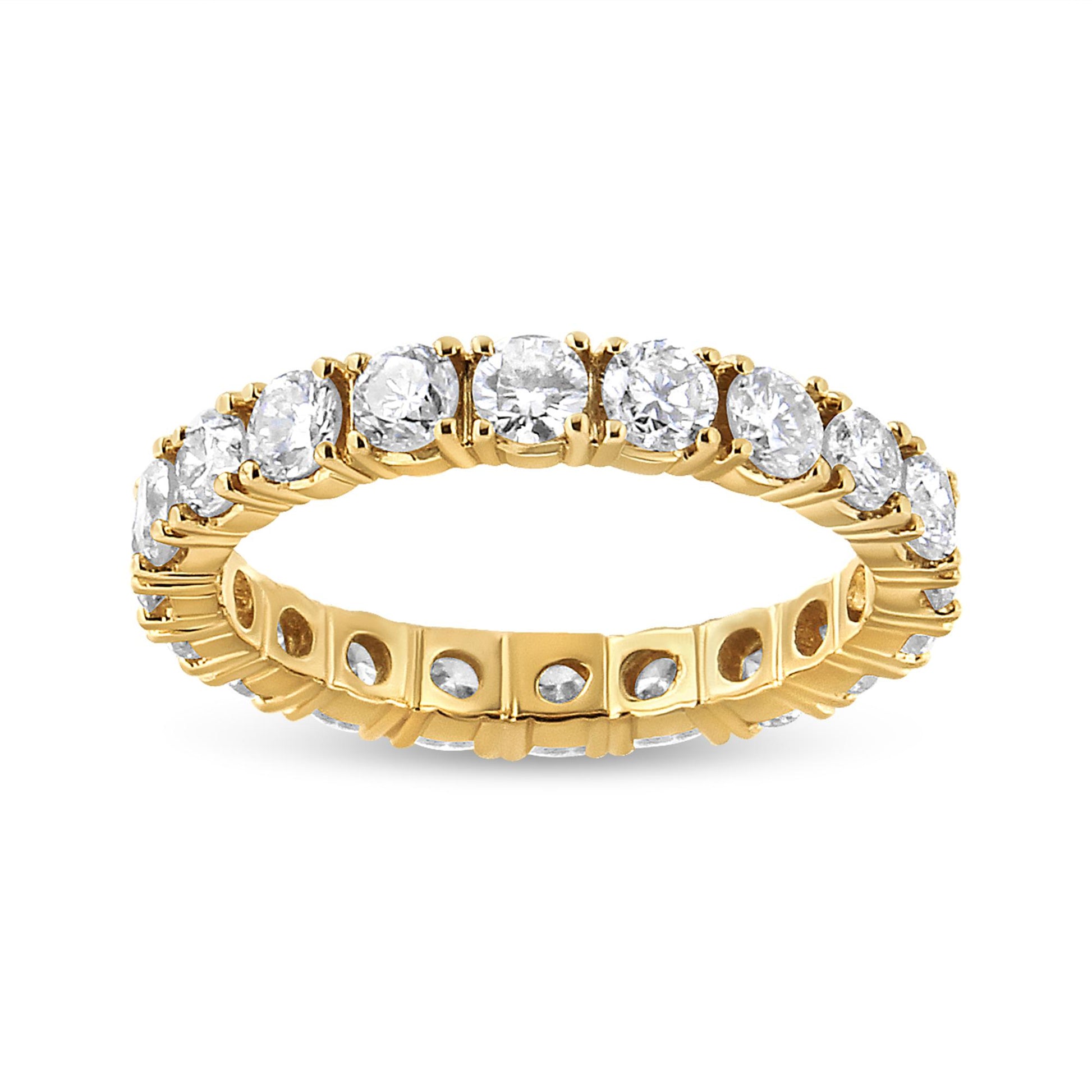 Yellow metal eternity ring with round white gemstones in prong settings, shown from a front angled view.