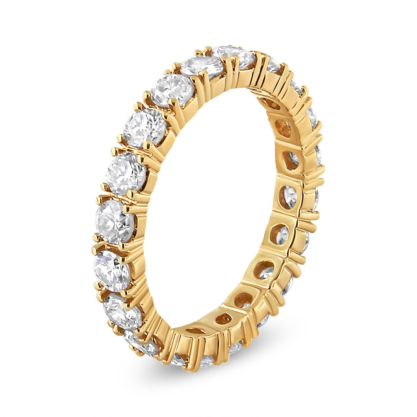 Angle shot of a yellow metal ring featuring round white gemstones in prong settings encircling the entire band.