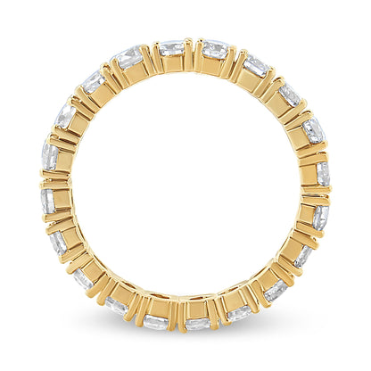 Top-down view of a yellow metal ring with multiple round white gemstones in prong settings encircling the band.