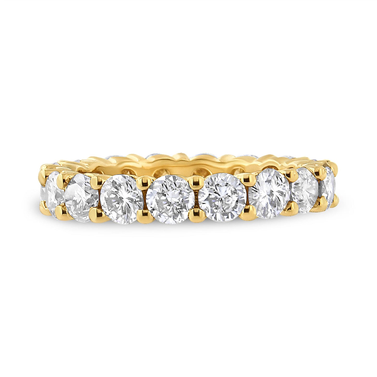 Side angle view of a yellow metal ring with round white gemstones in prong settings encircling the band.