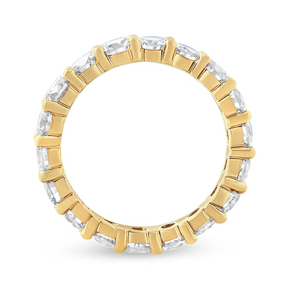 Top-down view of a yellow ring featuring round white gemstones in prong settings encircling the band.
