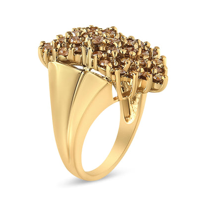 Yellow metal ring with a cluster of round champagne-colored gemstones in prong settings, shown at an angled side view.