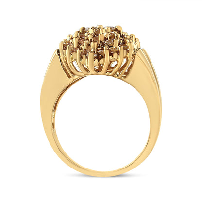 Yellow metal ring with round champagne-colored gemstones in prong settings, shown from a side angle.