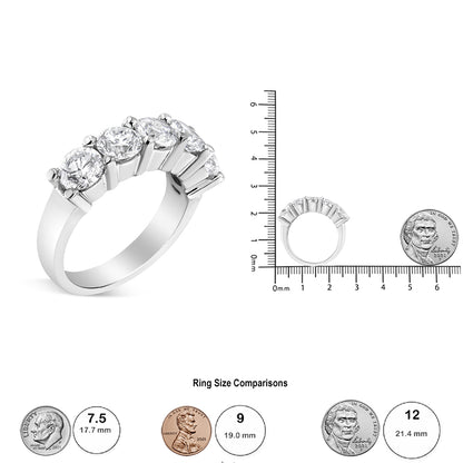 White metal ring with round white gemstones in a shared prong setting, shown angled and also placed upright next to a ruler and coin for size reference.