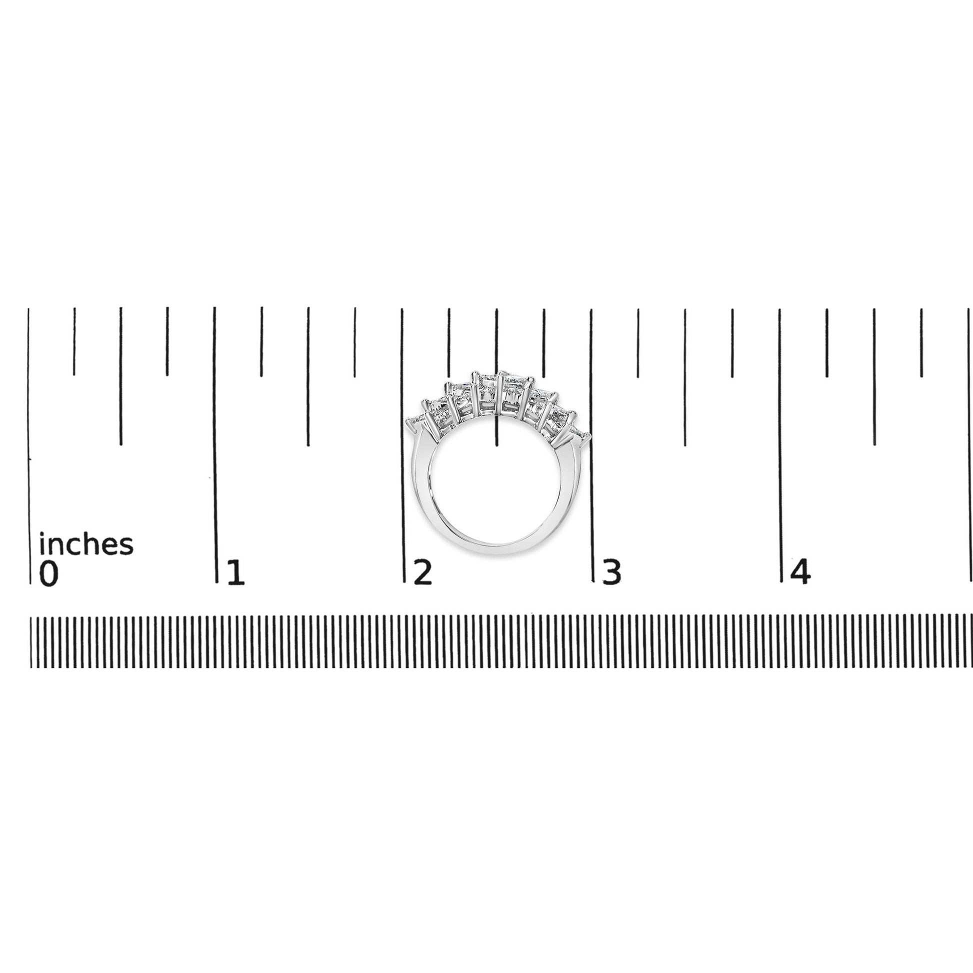 White metal ring shown on a scale, front angle, featuring two rows of white princess shape gemstones with invisible settings.