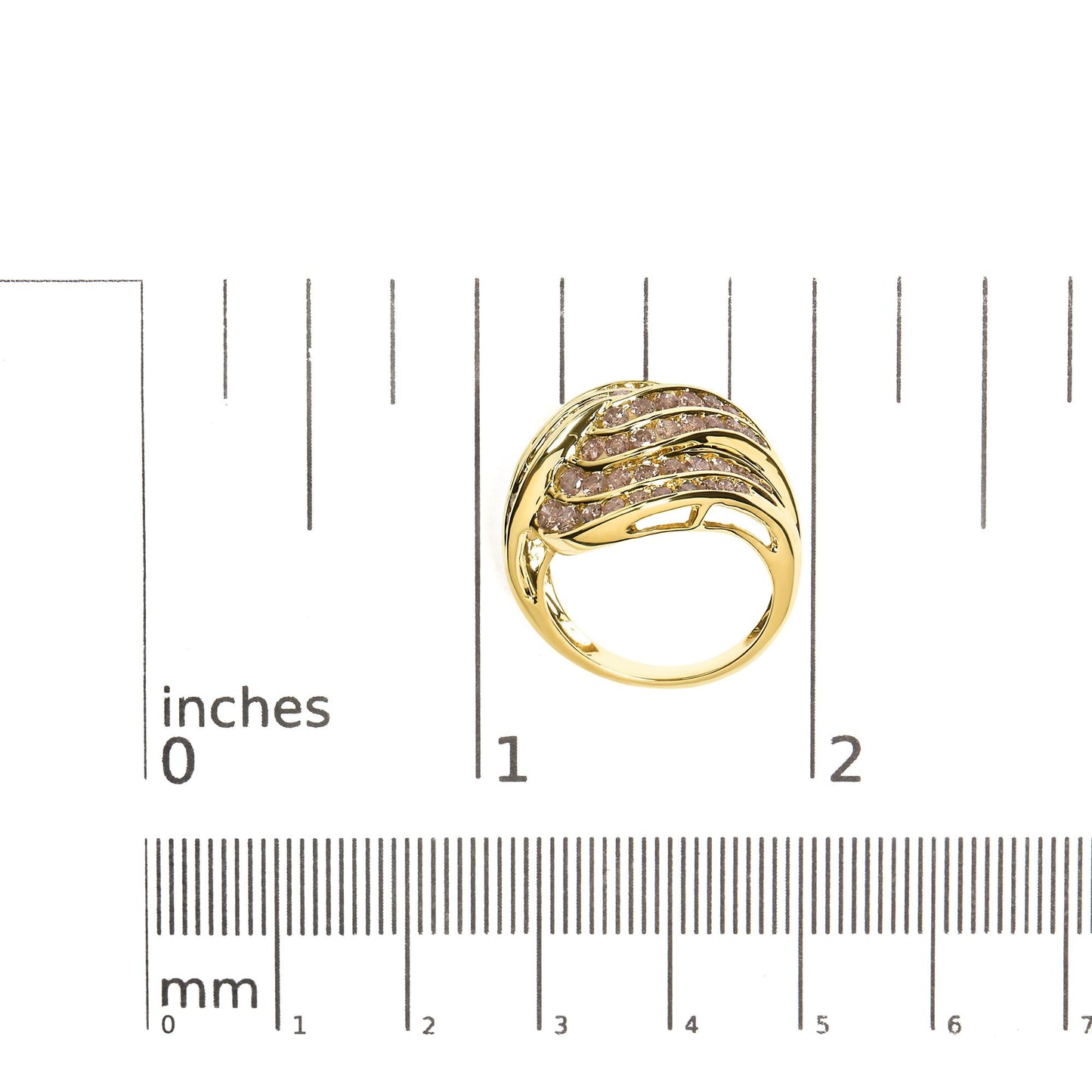 Top-down view of a yellow metal ring with multiple rows of channel-set round brownish gemstones, shown on a ruler for size reference.