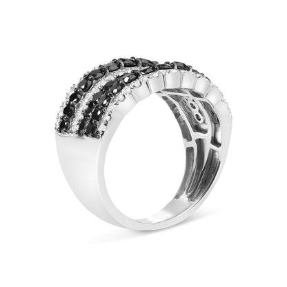 Angled close-up of a white metal ring featuring multiple rows of prong-set black and white round gemstones.