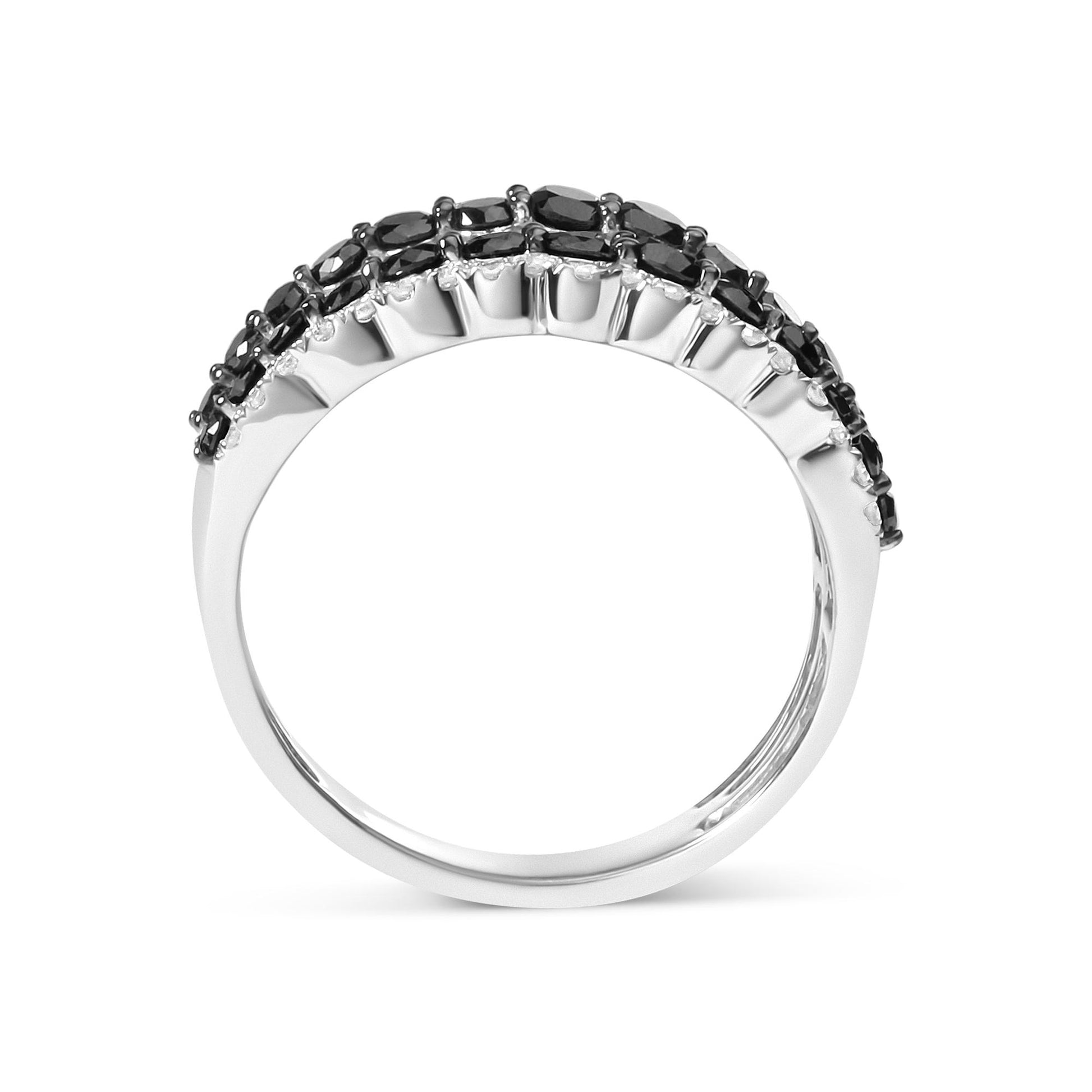 White metal ring with curved band featuring rows of round black gemstones on top, shown from side angle.