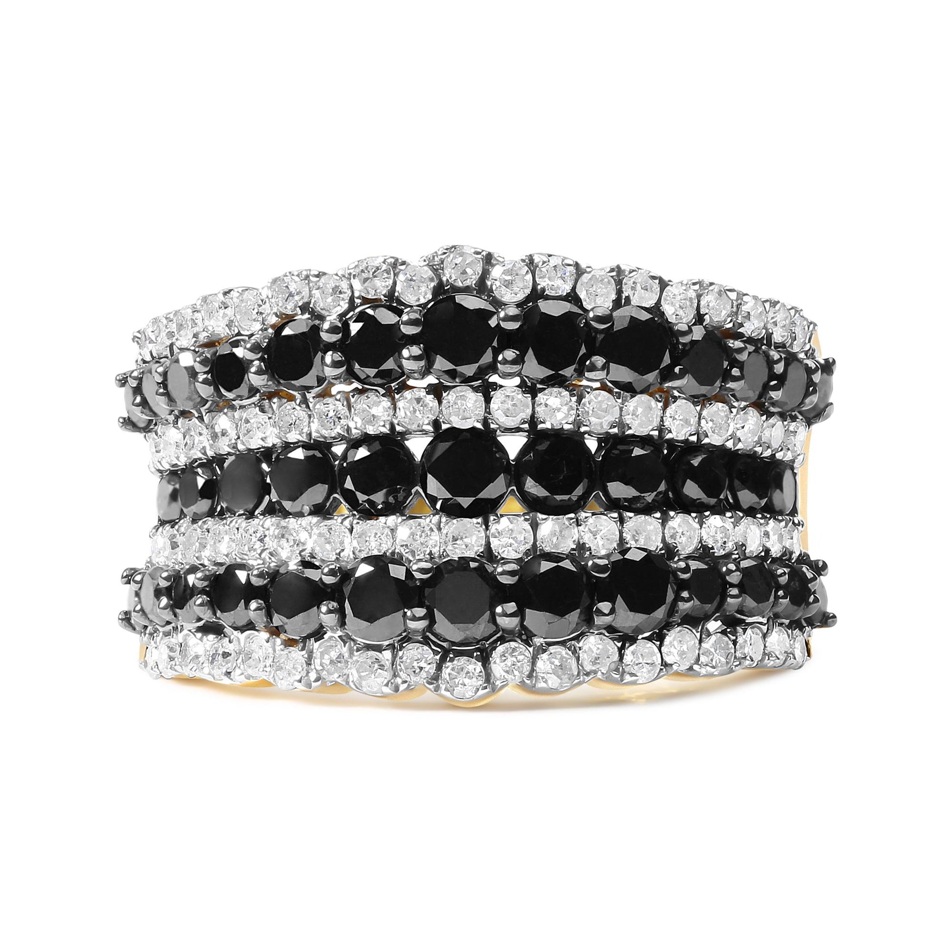 Close-up front view of a yellow ring with alternating rows of round black and white prong-set gemstones.
