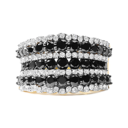 Close-up front view of a yellow ring with alternating rows of round black and white prong-set gemstones.