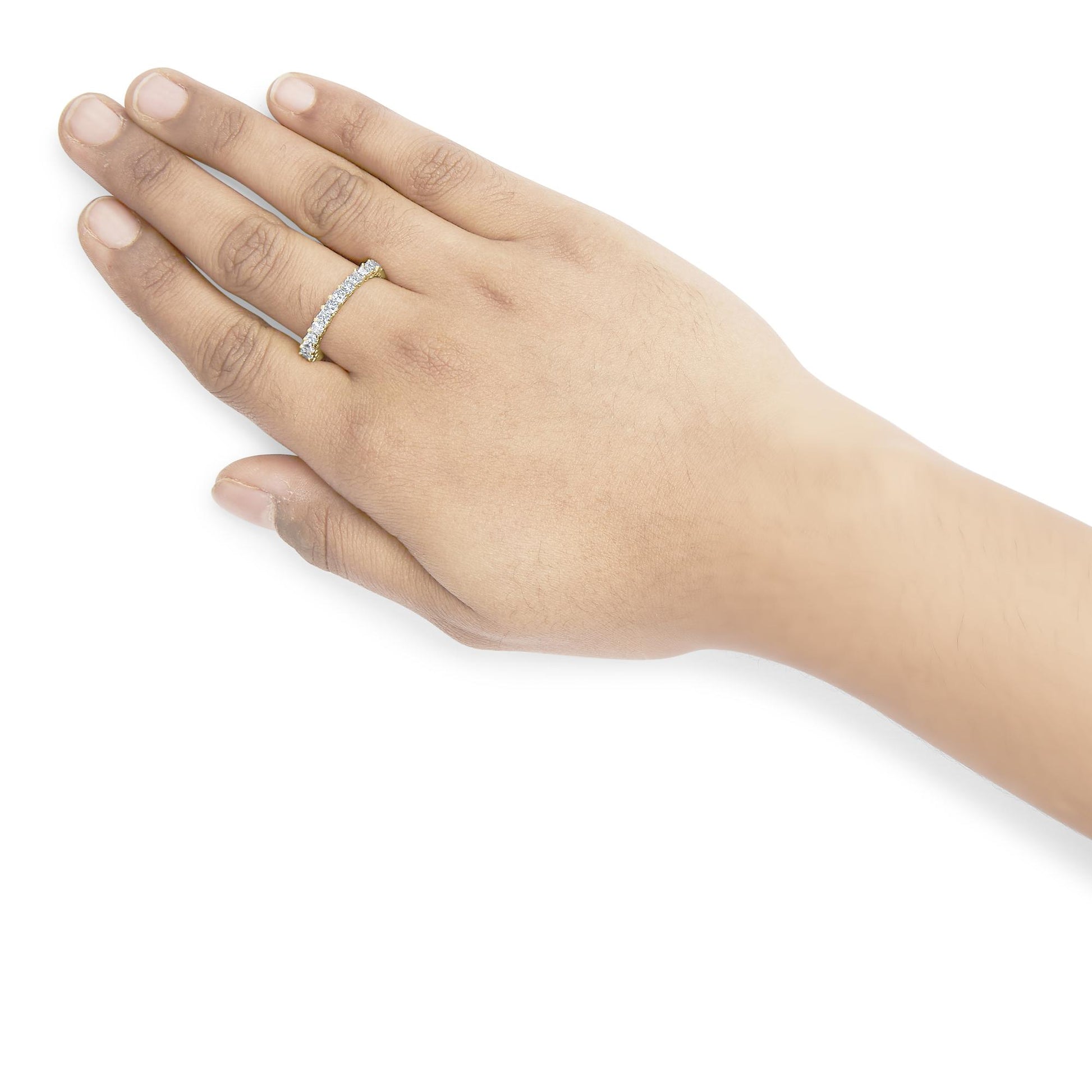 Yellow metal ring with white princess shape gemstones in shared prong setting, worn on a model's hand, angled from above.