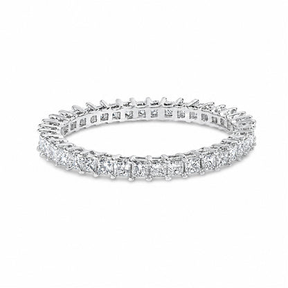 Close-up shot of a white ring featuring a continuous row of princess-shaped white gemstones in prong settings, shown on a white background.